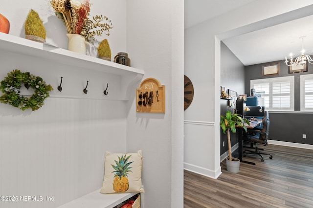 mudroom featuring baseboards, wood finished floors, and a notable chandelier