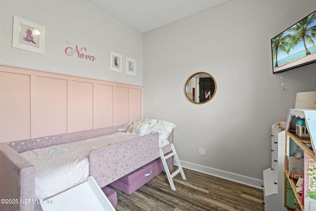 bedroom with baseboards and wood finished floors