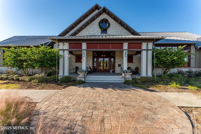 view of front of property featuring covered porch, metal roof, and french doors