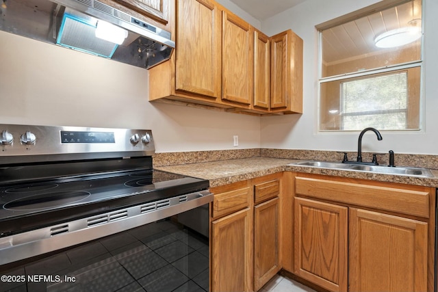 kitchen with ventilation hood, stainless steel electric range, light tile patterned floors, and sink