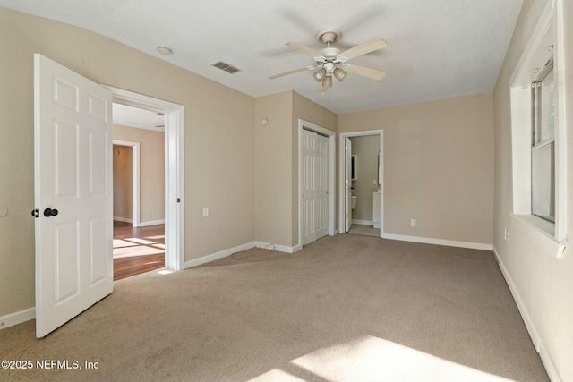 unfurnished bedroom featuring ceiling fan, a closet, and carpet floors