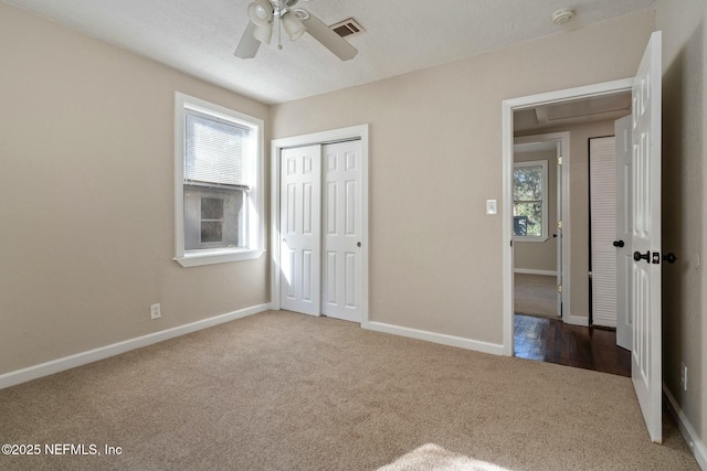 unfurnished bedroom with carpet floors, a closet, and ceiling fan