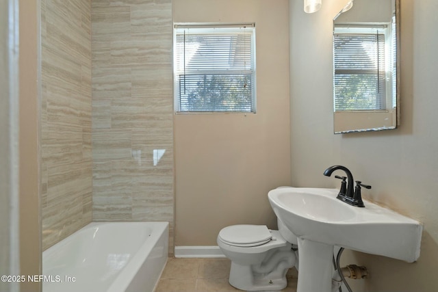 bathroom featuring toilet, tile patterned floors, and a bathtub