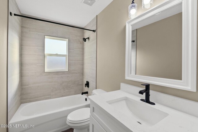 full bathroom featuring vanity, toilet, and tiled shower / bath