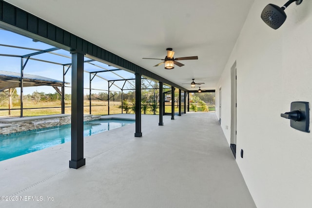 view of pool with glass enclosure and a patio area