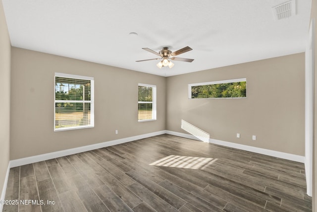 unfurnished room with ceiling fan and dark hardwood / wood-style flooring