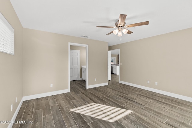 unfurnished bedroom featuring ceiling fan and dark hardwood / wood-style floors