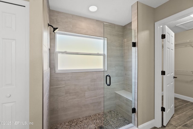 bathroom with a shower with door