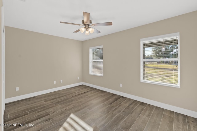 unfurnished room with dark hardwood / wood-style flooring and ceiling fan