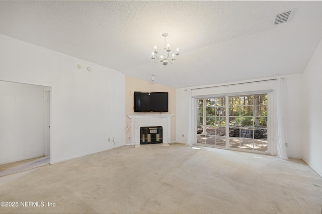 unfurnished living room with a textured ceiling, light carpet, lofted ceiling, and a notable chandelier