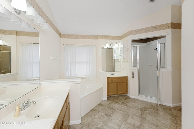 bathroom with vanity, vaulted ceiling, and independent shower and bath