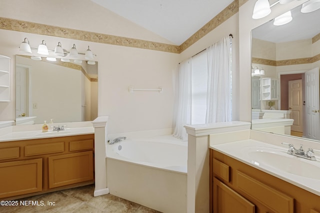 bathroom featuring a washtub, vanity, and lofted ceiling