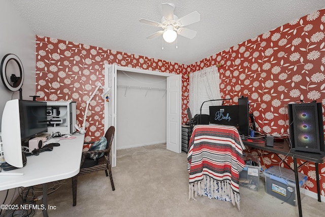 bedroom featuring carpet, a textured ceiling, a closet, and ceiling fan