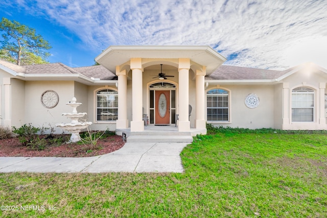 doorway to property with a lawn