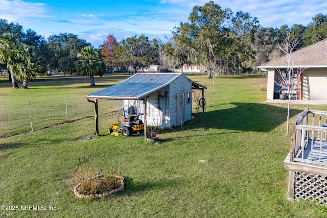 view of yard featuring a deck and a storage shed