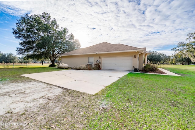 view of side of home with a lawn and a garage