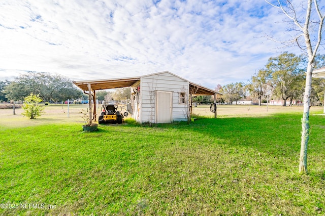 view of yard with an outdoor structure and a carport