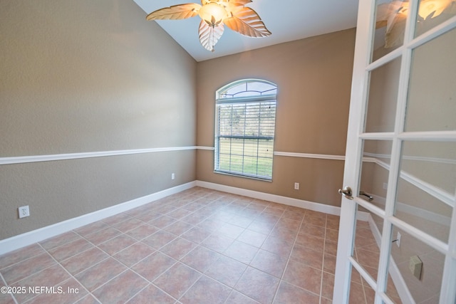 spare room with ceiling fan, light tile patterned flooring, lofted ceiling, and french doors