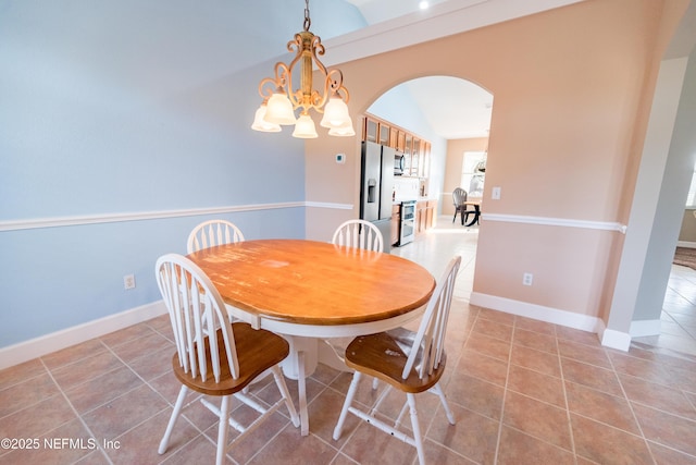 dining space with light tile patterned floors and a notable chandelier