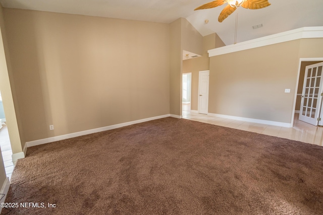 unfurnished room with ceiling fan, light carpet, and high vaulted ceiling