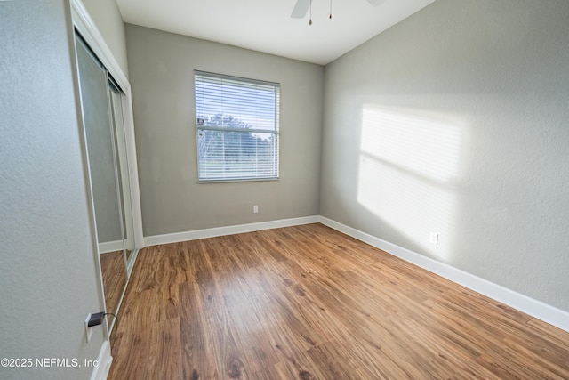 unfurnished bedroom featuring a closet, ceiling fan, and hardwood / wood-style floors