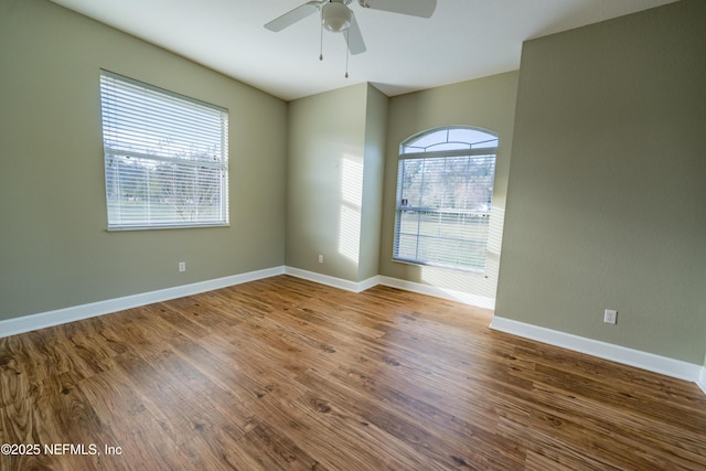 spare room featuring hardwood / wood-style floors and ceiling fan