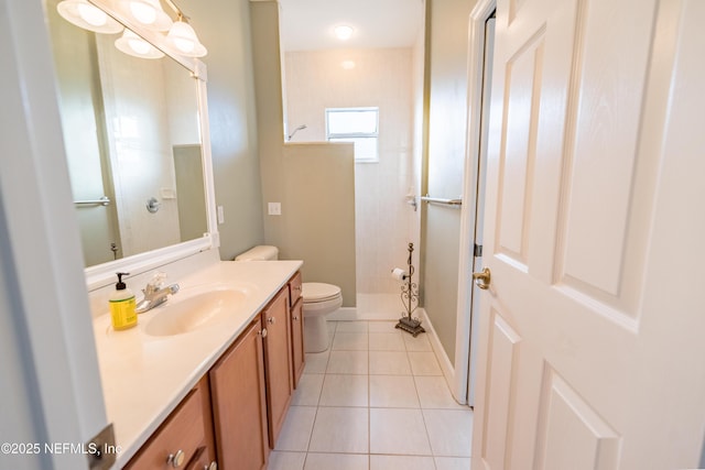 bathroom featuring tile patterned floors, toilet, a tile shower, and vanity