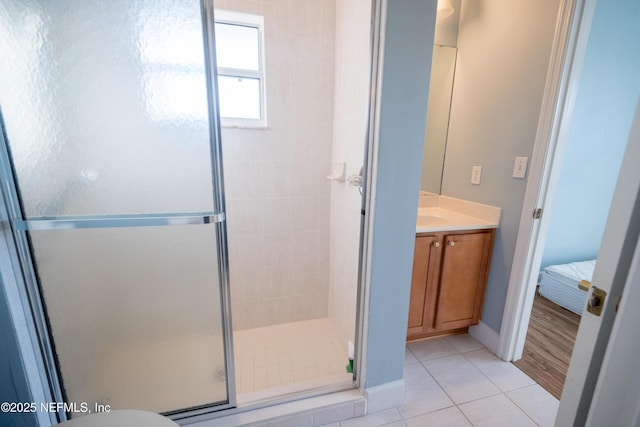 bathroom with vanity, tile patterned floors, and a shower with door