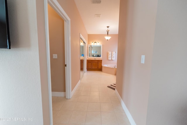 hallway with light tile patterned flooring