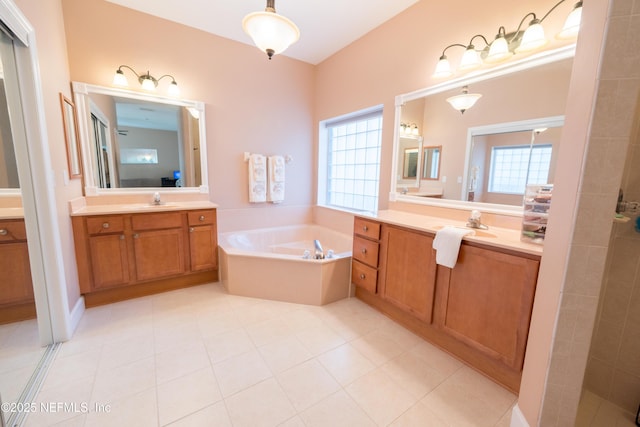 bathroom featuring tile patterned flooring, vanity, and separate shower and tub