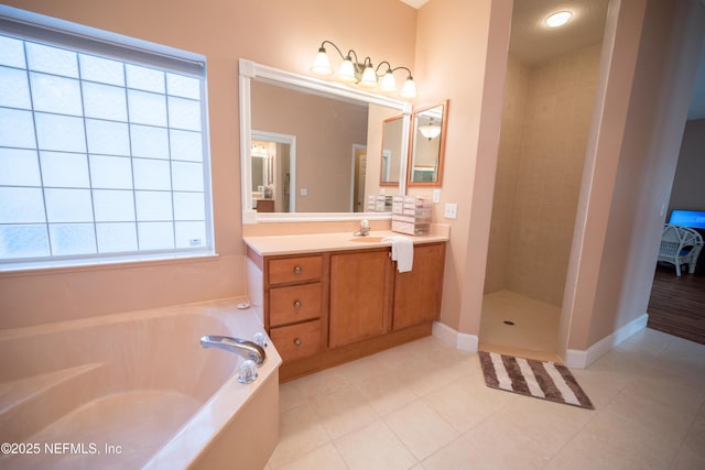 bathroom with tile patterned flooring, vanity, and plus walk in shower