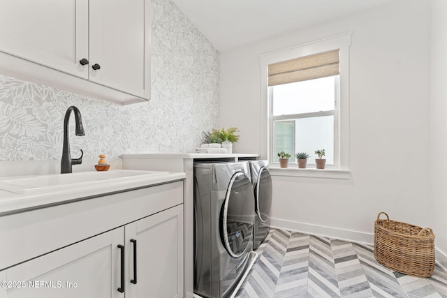 laundry room with cabinets, sink, and washing machine and dryer