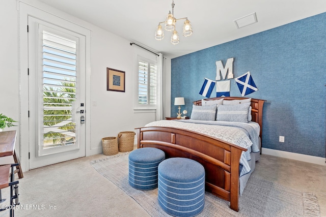 carpeted bedroom featuring an inviting chandelier