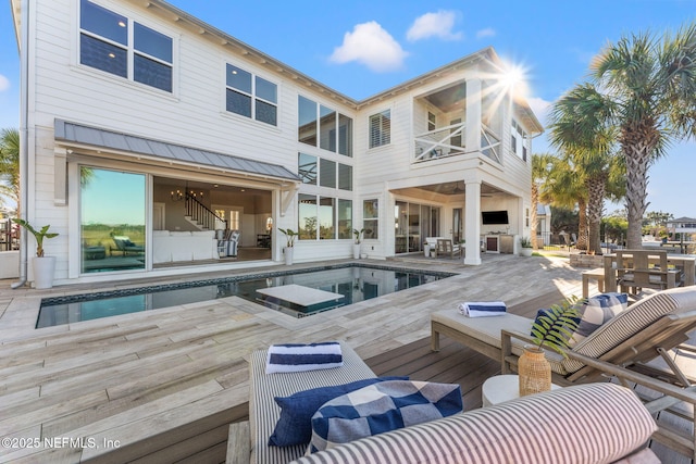 rear view of house with a swimming pool side deck