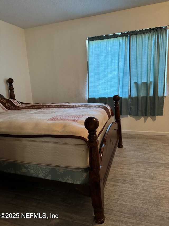 bedroom with light wood-type flooring