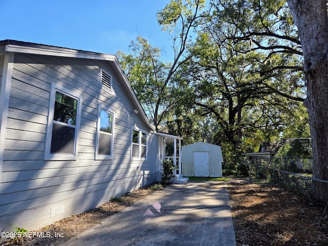 view of side of property with a shed