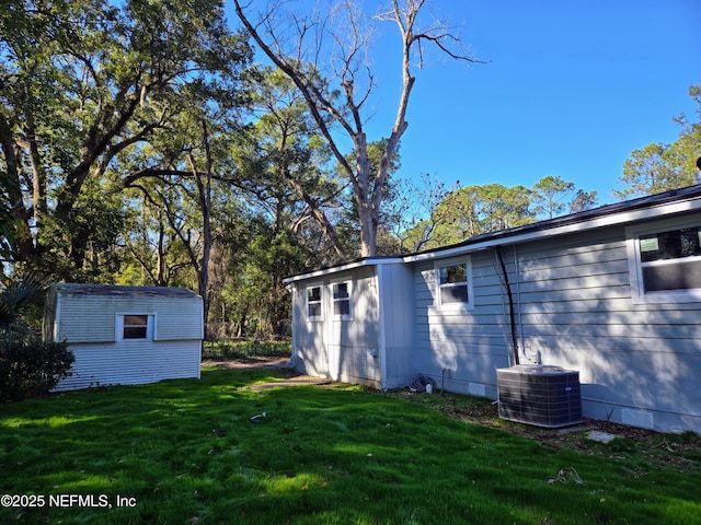 view of yard with cooling unit and a shed