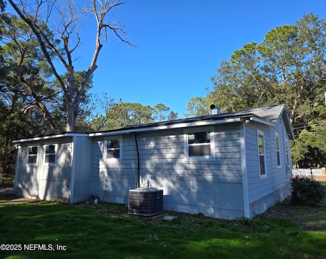 back of house with a yard and cooling unit