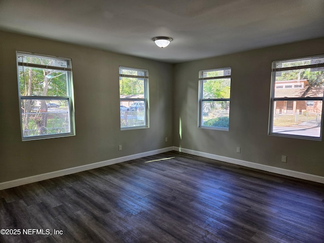 unfurnished room featuring dark hardwood / wood-style flooring