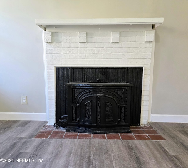 details featuring wood-type flooring and a wood stove