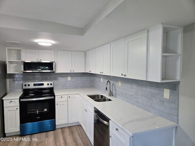 kitchen featuring stainless steel appliances, white cabinetry, dark wood-type flooring, and sink