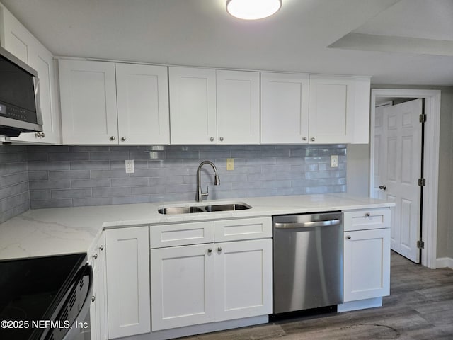 kitchen with white cabinetry, sink, tasteful backsplash, dark hardwood / wood-style floors, and appliances with stainless steel finishes