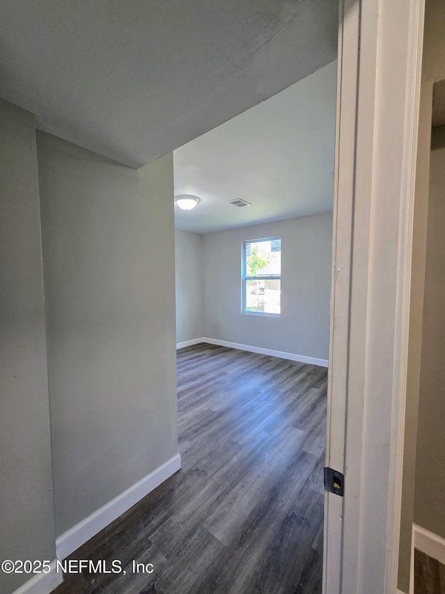 unfurnished room with dark hardwood / wood-style floors