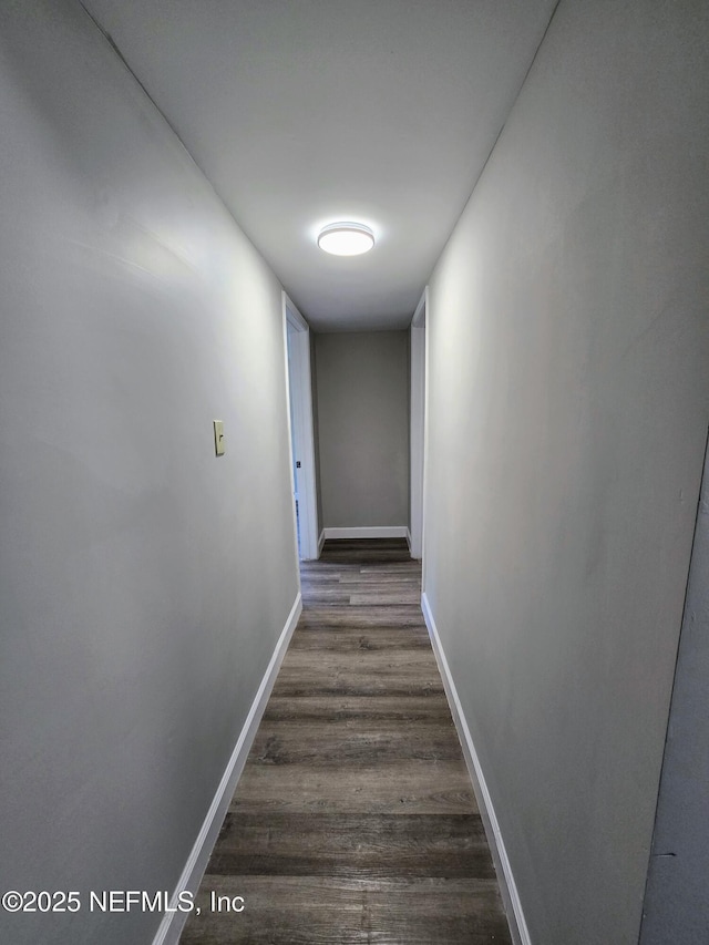 hall with dark wood-type flooring