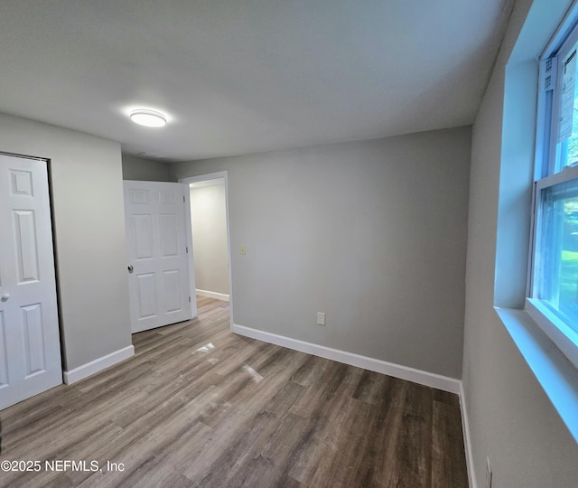 unfurnished bedroom with wood-type flooring