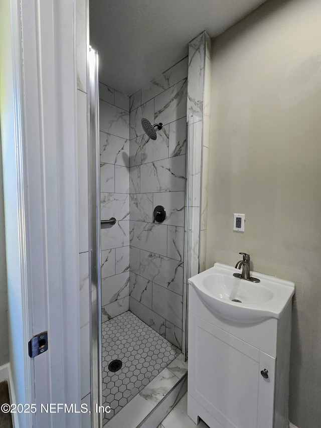 bathroom featuring vanity and a tile shower