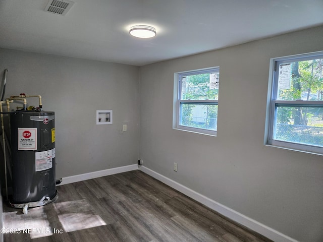 laundry area featuring washer hookup, plenty of natural light, dark wood-type flooring, and water heater