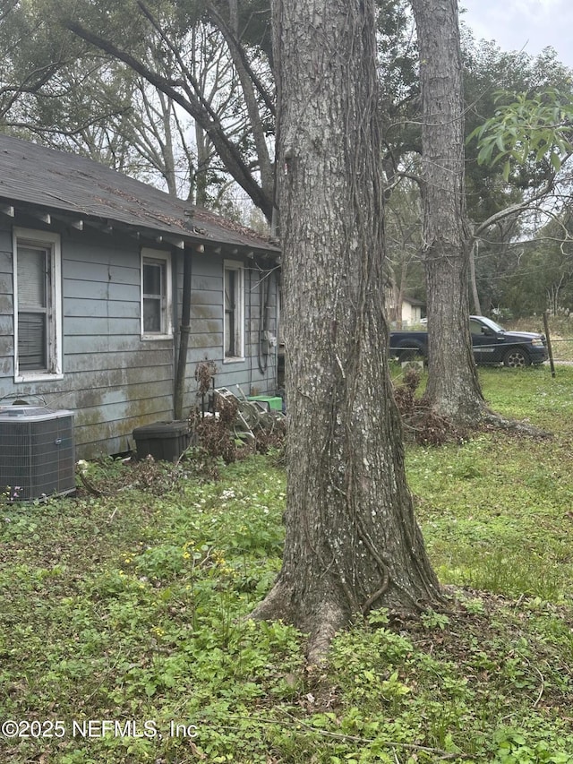 view of side of home with central AC