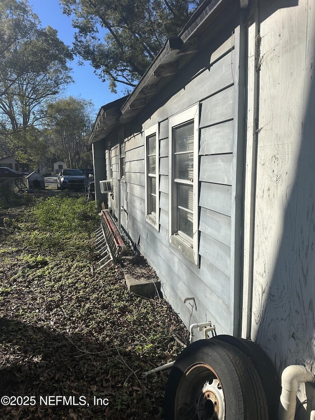 view of side of home with cooling unit