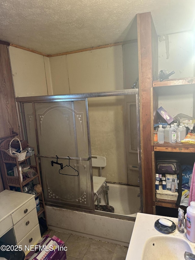 bathroom with tile patterned floors and a textured ceiling